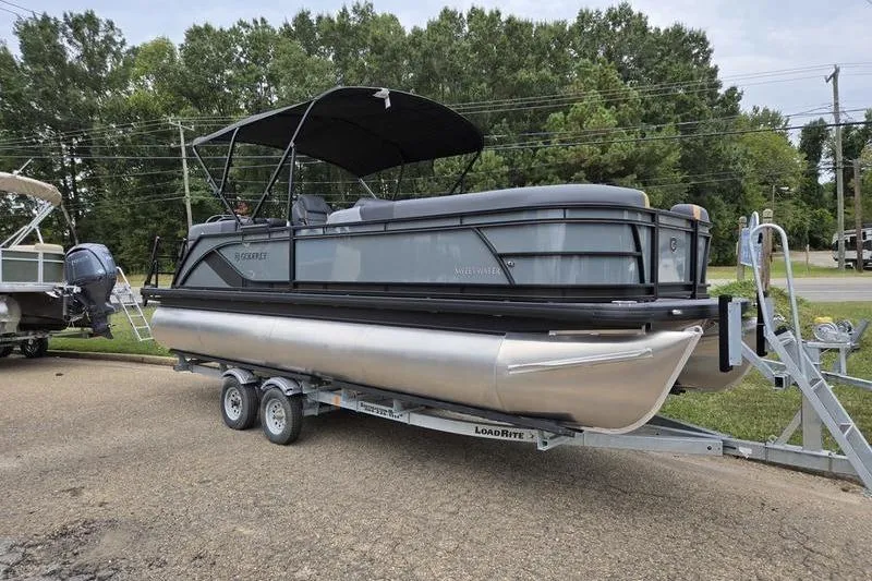 Slide: The Image of 2026 Godfrey SWEETWATER 2286 SB pontoon boat on trailer, parked outdoors. - 4