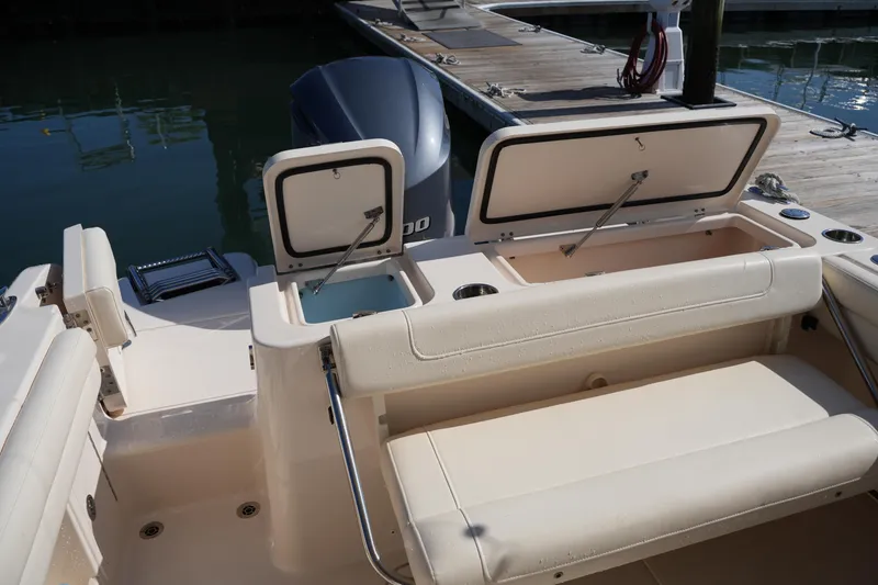 Slide: The Image of 2019 Grady-White Freedom 235 boat interior with open storage compartments at dock. - 15