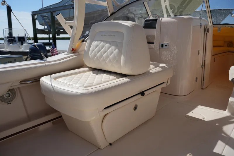 Slide: The Image of 2019 Grady-White Freedom 235 boat interior with cushioned seating and storage. - 18