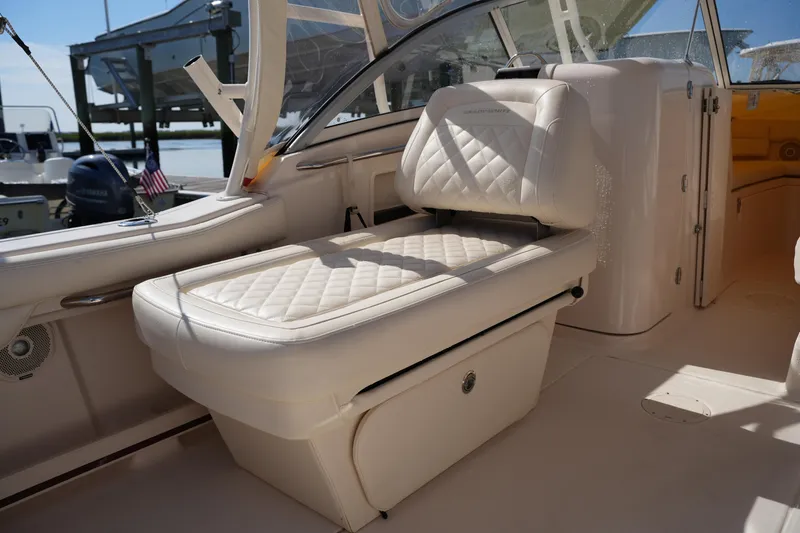 Slide: The Image of 2019 Grady-White Freedom 235 boat interior with cushioned seating and sleek design. - 19