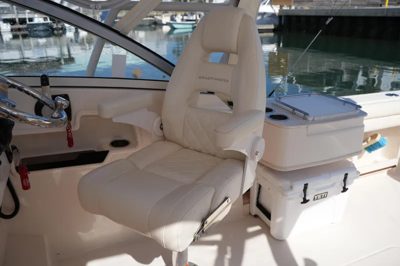 Slide: The Image of Captain's chair on 2019 Grady-White Freedom 235 boat, with Yeti cooler nearby. - 20
