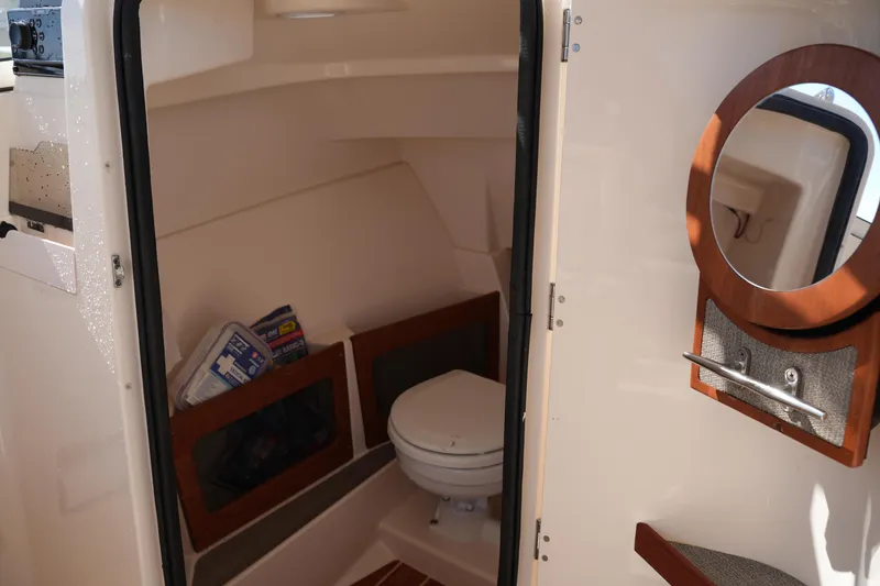 Slide: The Image of 2019 Grady-White Freedom 235 boat interior with toilet and storage compartments. - 29