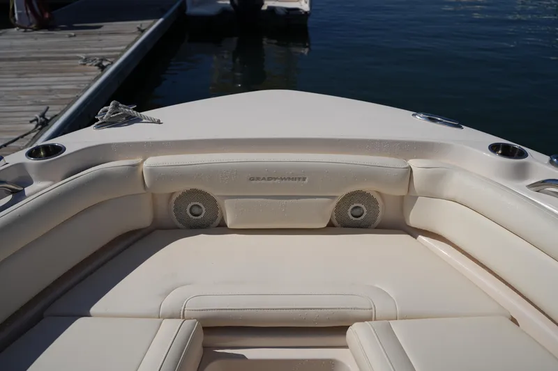 Slide: The Image of 2019 Grady-White Freedom 235 boat interior with cushioned seating and speakers. - 32
