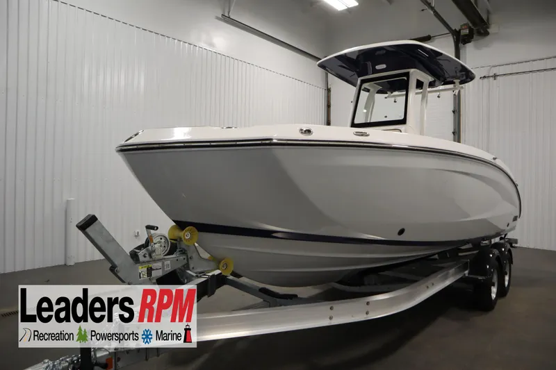 The Image of 2026 Yamaha Boats 252 FSH Sport on trailer in indoor showroom. - 0