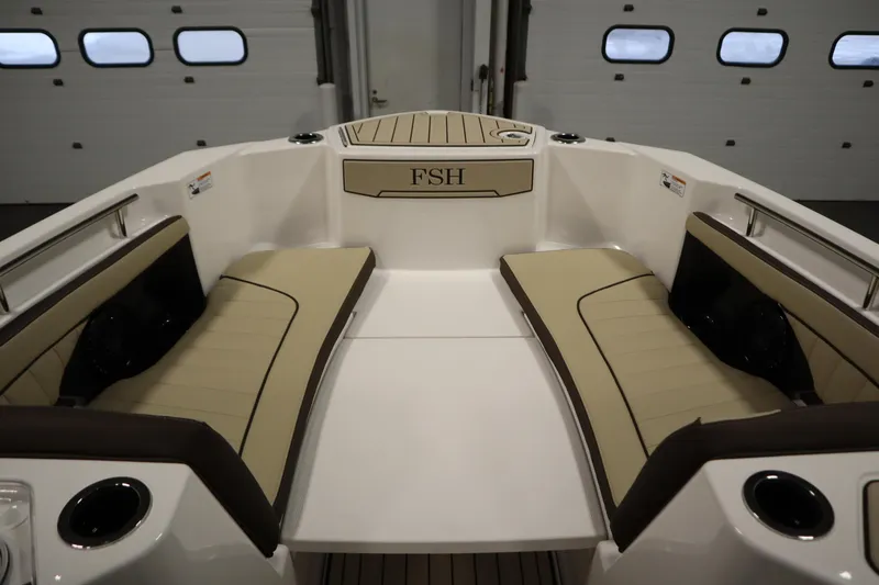 Slide: The Image of 2026 Yamaha Boats 252 FSH Sport interior with beige seating and cup holders. - 10