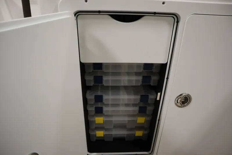 Slide: The Image of Storage compartment with tackle boxes on a 2026 Yamaha Boats 252 FSH Sport. - 17