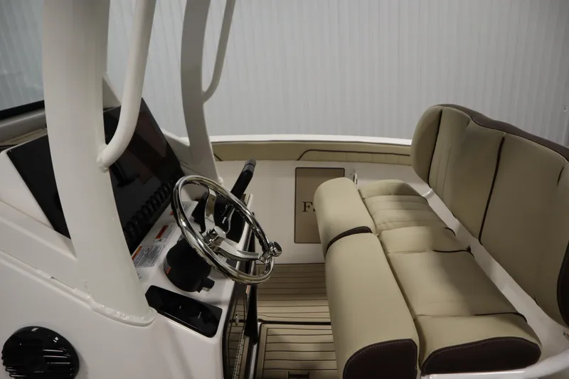 Slide: The Image of 2026 Yamaha Boats 252 FSH Sport interior with steering wheel and cushioned seating. - 21