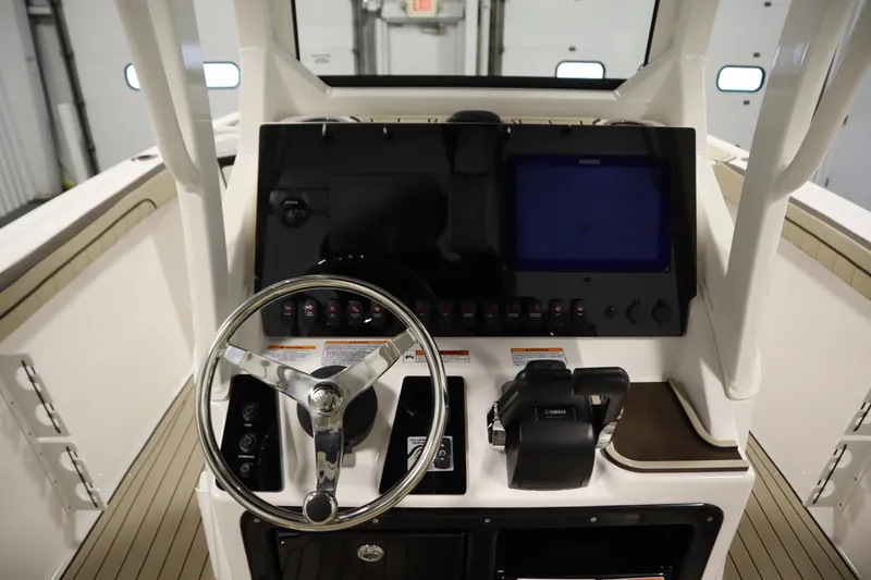 Slide: The Image of 2026 Yamaha Boats 252 FSH Sport dashboard with steering wheel and control panel. - 22