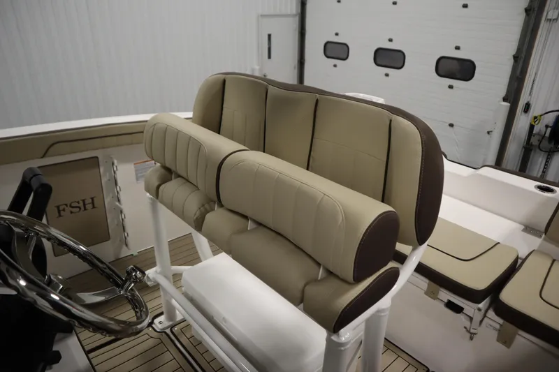 Slide: The Image of 2026 Yamaha Boats 252 FSH Sport interior with beige seating and steering wheel. - 31