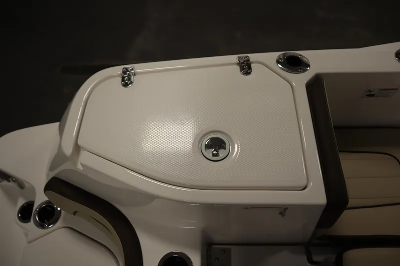 Slide: The Image of 2026 Yamaha Boats 252 FSH Sport deck detail with storage compartment and cup holders. - 36
