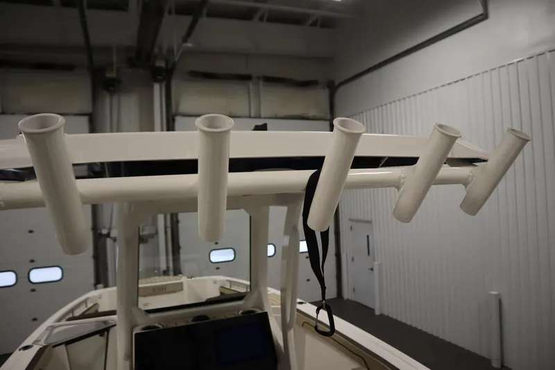 Slide: The Image of 2026 Yamaha Boats 252 FSH Sport fishing rod holders in a garage setting. - 38