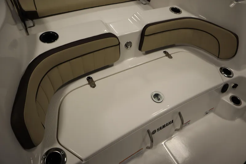 Slide: The Image of 2026 Yamaha Boats 252 FSH Sport interior seating with cup holders and storage. - 39