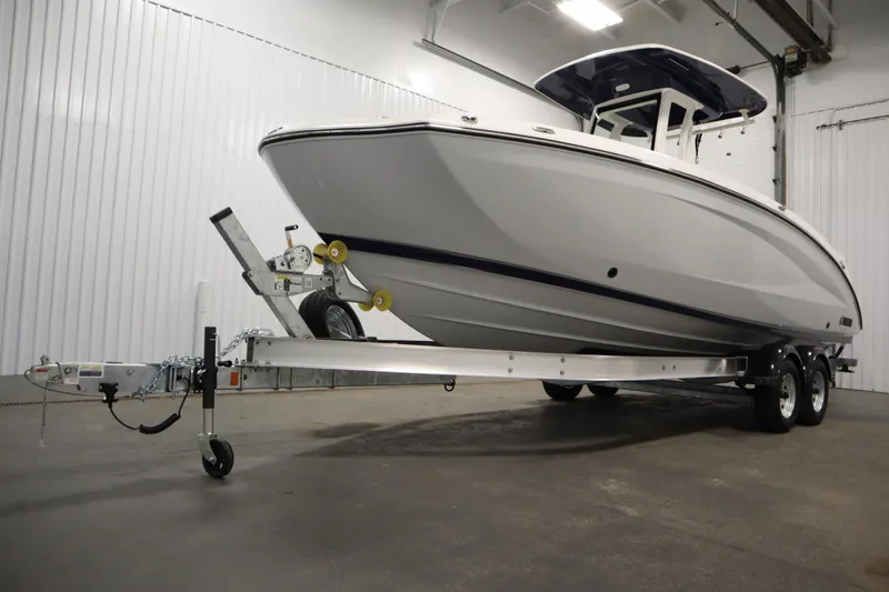 Slide: The Image of 2026 Yamaha Boats 252 FSH Sport on trailer in indoor storage facility. - 44