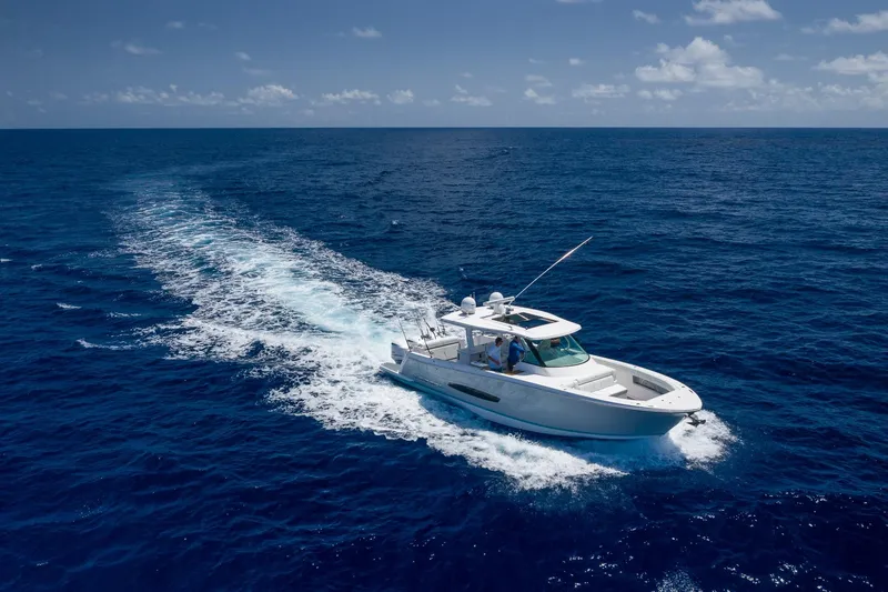 The Image of 2026 Regal 38 SAV cruising on open ocean under clear blue sky. - 0