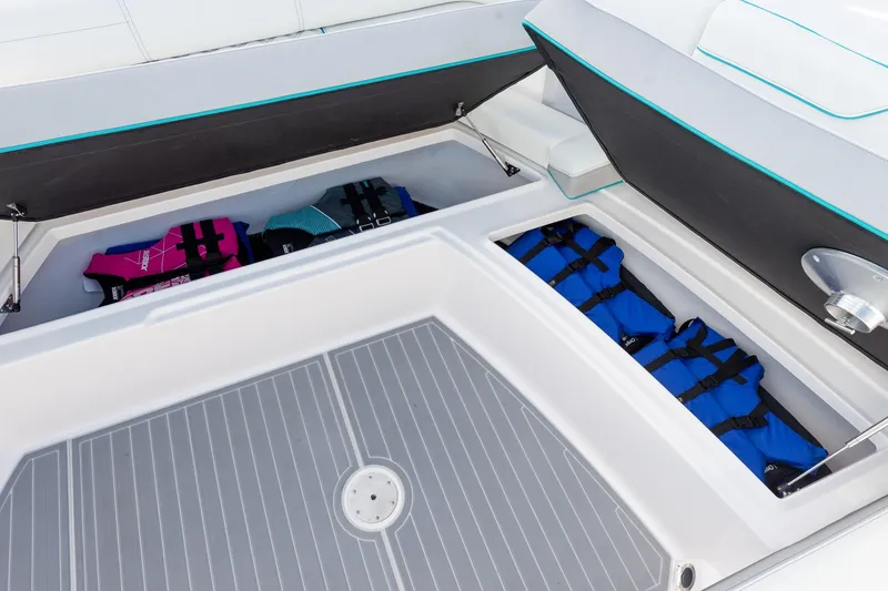 Slide: The Image of 2026 Regal 38 SAV boat storage compartment with life jackets. - 11