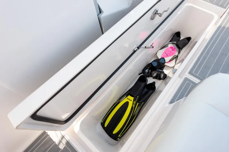 Slide: The Image of Storage compartment on 2026 Regal 38 SAV boat with snorkeling gear and flippers. - 12