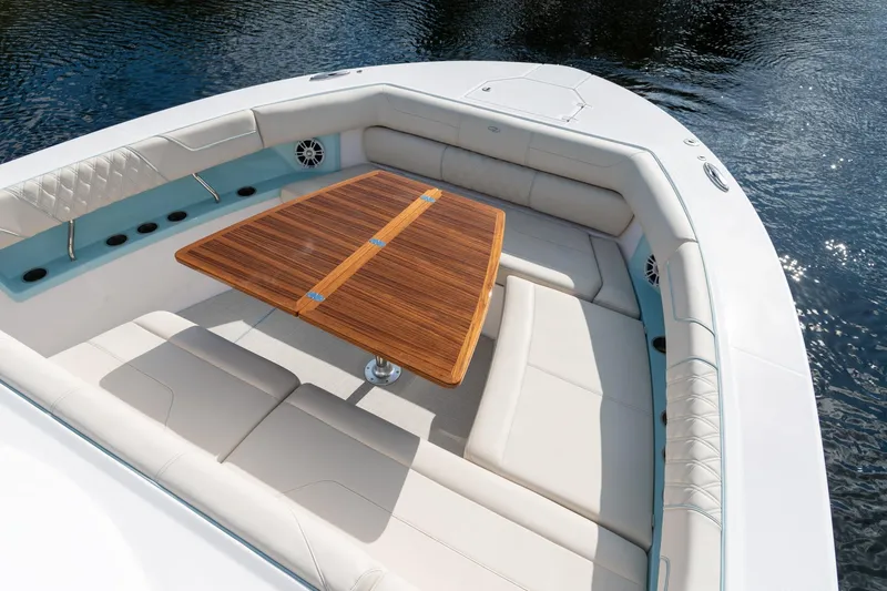 Slide: The Image of Luxurious seating area on 2026 Regal 38 SAV boat with elegant wooden table. - 25