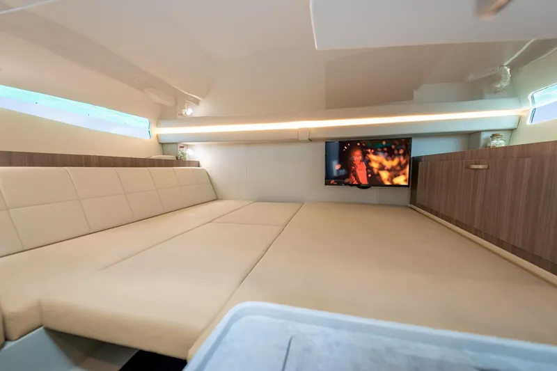 Slide: The Image of Luxurious interior of 2026 Regal 38 SAV yacht with plush seating and mounted TV. - 29
