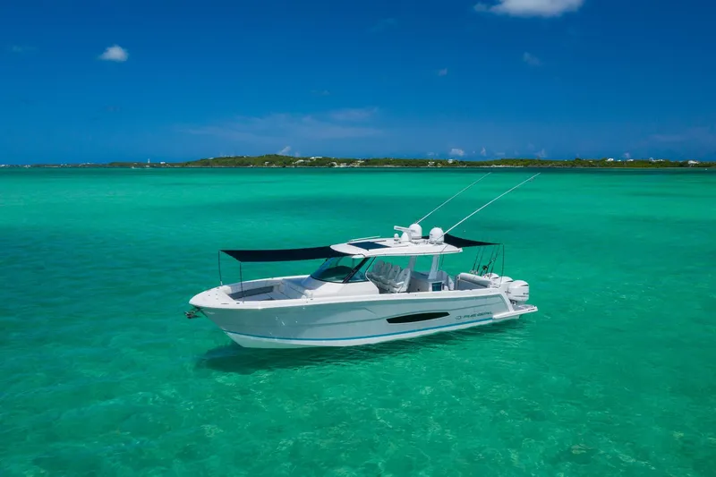 Slide: The Image of 2026 Regal 38 SAV boat on turquoise water under clear blue sky. - 32