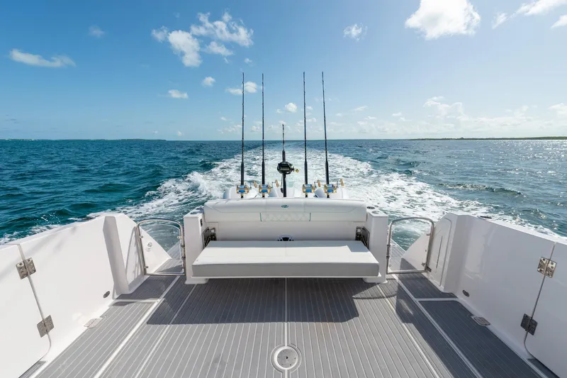 Slide: The Image of 2026 Regal 38 SAV boat cruising on open water, featuring fishing rods and a spacious deck. - 6