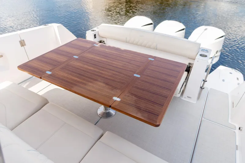 Slide: The Image of Luxurious 2026 Regal 38 SAV boat interior with elegant wooden table and comfortable seating. - 7