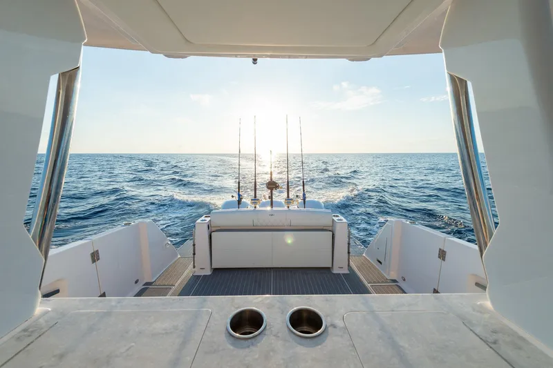 Slide: The Image of 2026 Regal 38 SAV boat with fishing rods, ocean view at sunset. - 8