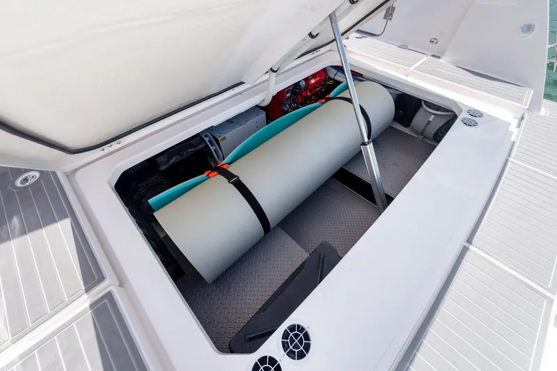 Slide: The Image of Open storage compartment on 2026 Regal 38 SAV boat, featuring organized equipment and gear. - 9