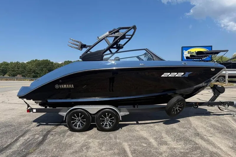 The Image of 2026 Yamaha Boats 222XE on trailer, sleek black design, parked outdoors. - 0