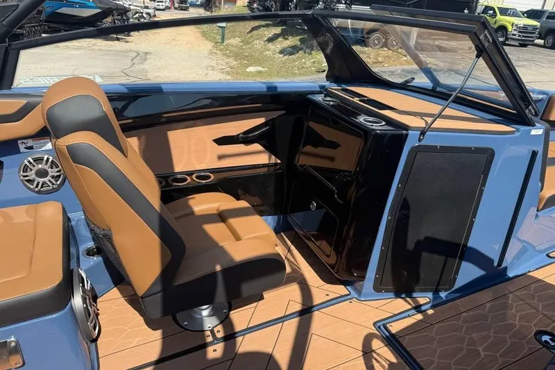 Slide: The Image of 2026 Yamaha Boats 222XE interior with tan and black seating, modern dashboard, and sleek design. - 10