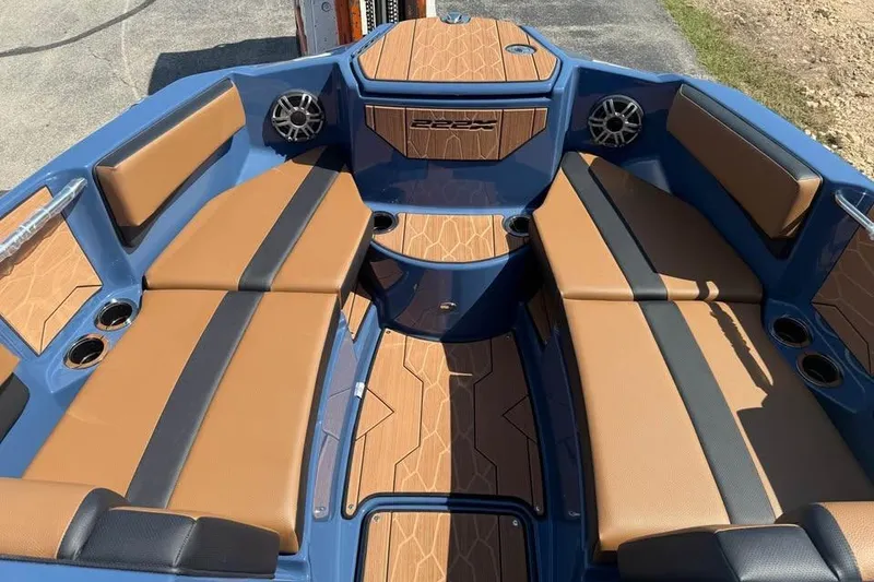 Slide: The Image of 2026 Yamaha Boats 222XE interior with tan and black seating, blue accents, and cup holders. - 11