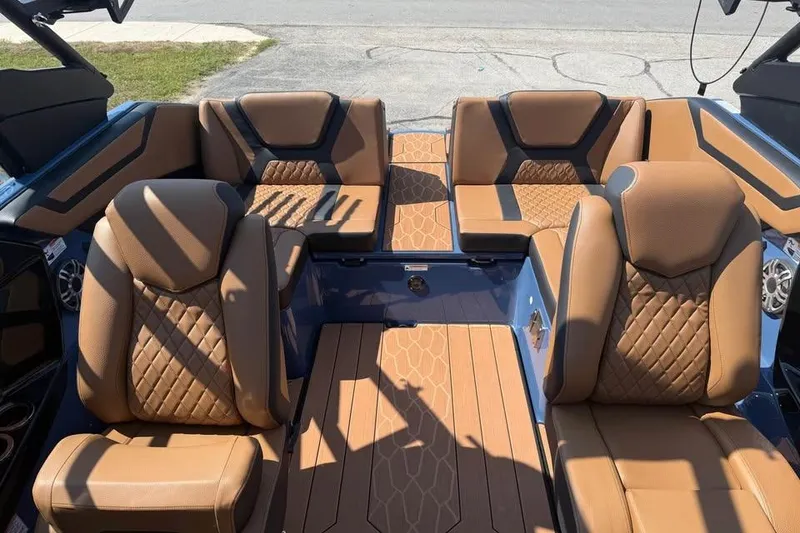 Slide: The Image of Luxurious interior of 2026 Yamaha Boats 222XE with brown leather seating and modern design. - 12