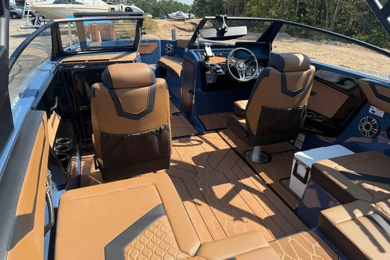 Slide: The Image of 2026 Yamaha Boats 222XE interior with brown seating and modern dashboard design. - 6