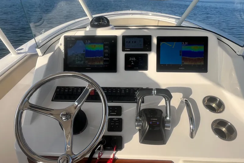 Slide: The Image of Helm of 2016 Pursuit S 280 Sport boat with Garmin displays and Yamaha controls. - 12