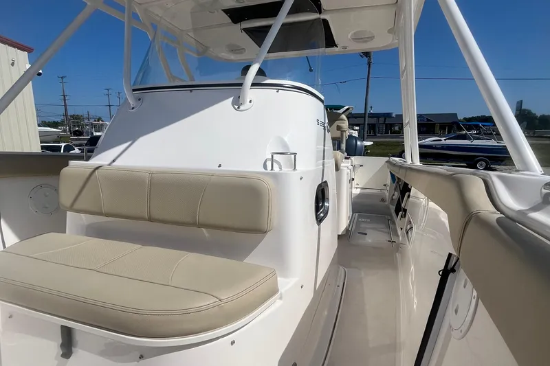 Slide: The Image of 2016 Pursuit S 280 Sport boat interior with beige seating and modern design. - 14