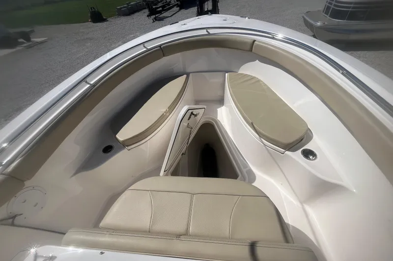 Slide: The Image of 2016 Pursuit S 280 Sport boat interior with beige seating and storage compartment. - 6