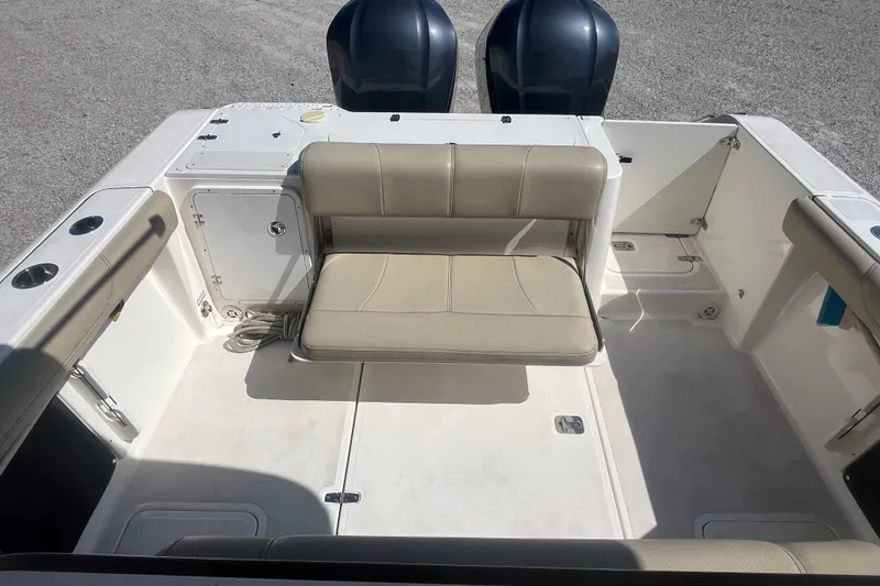 Slide: The Image of 2016 Pursuit S 280 Sport boat interior with beige seating and dual engines. - 8