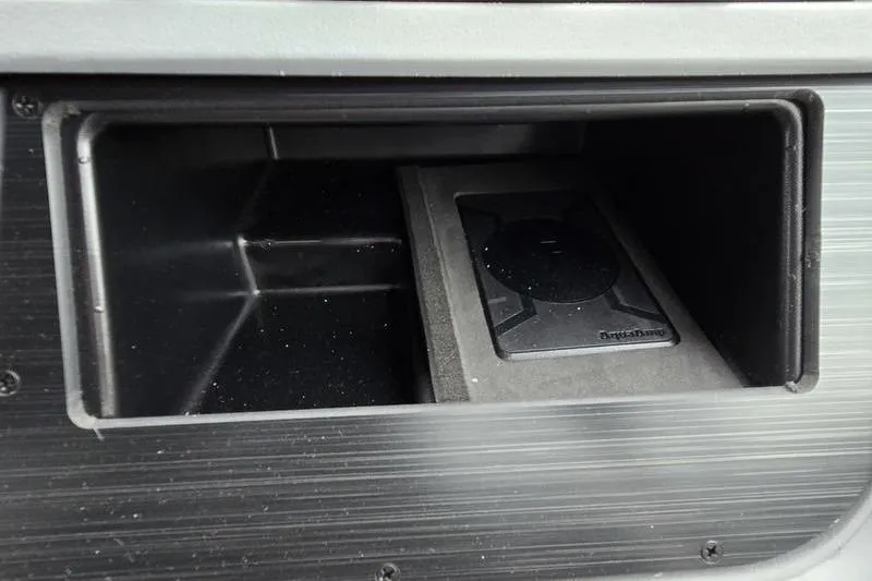 Slide: The Image of Storage compartment in 2026 Godfrey SWEETWATER 2286 SB boat, featuring a wireless charging pad. - 13