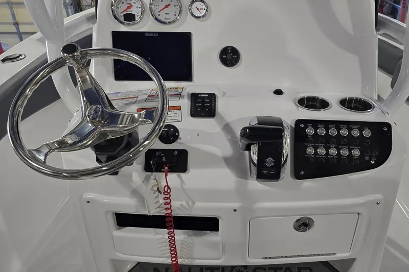 Slide: The Image of Control panel of 2026 NauticStar 222 Offshore boat with steering wheel and gauges. - 13