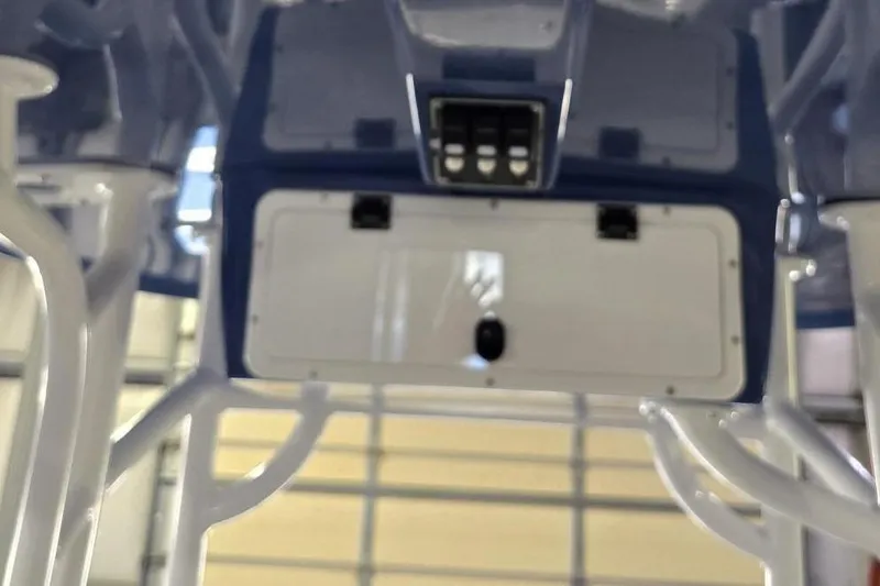 Slide: The Image of 2026 NauticStar 222 Offshore boat console with switches and storage compartment. - 15