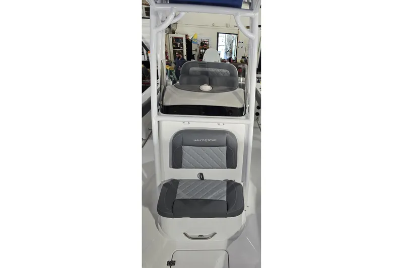 Slide: The Image of 2026 NauticStar 222 Offshore boat interior with gray cushioned seating. - 16