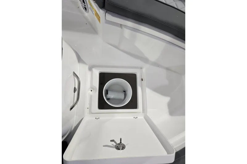 Slide: The Image of 2026 NauticStar 222 Offshore boat interior with storage compartment and cup holder. - 19