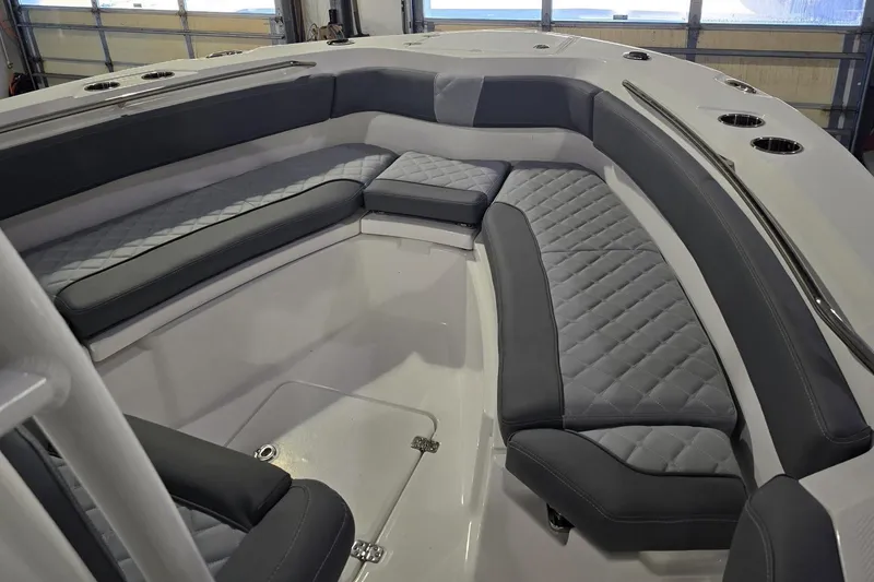Slide: The Image of 2026 NauticStar 222 Offshore boat interior with gray cushioned seating in a spacious layout. - 21