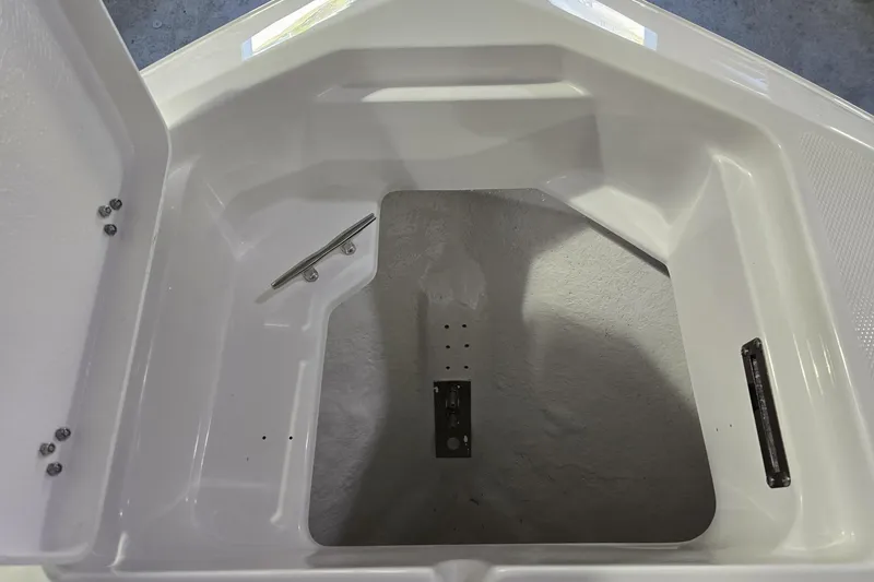 Slide: The Image of 2026 NauticStar 222 Offshore boat storage compartment, featuring a clean, white interior design. - 23