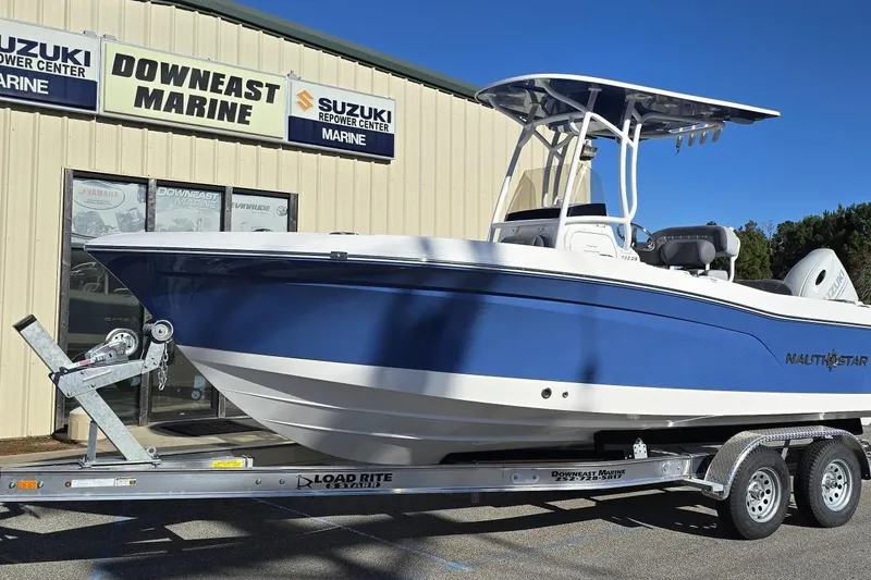 Slide: The Image of 2026 NauticStar 222 Offshore boat on trailer at Downeast Marine dealership. - 24