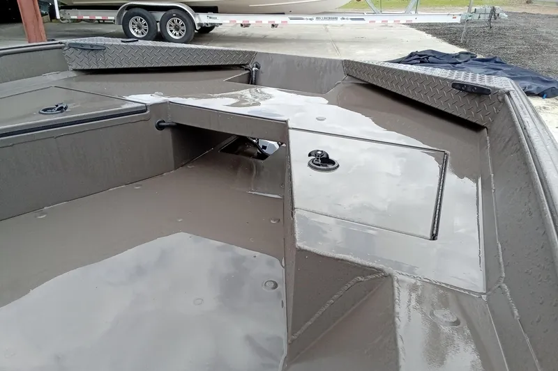 Slide: The Image of 2025 Alweld 1548 Invader boat on trailer with Tohatsu motor, parked outdoors. - 12