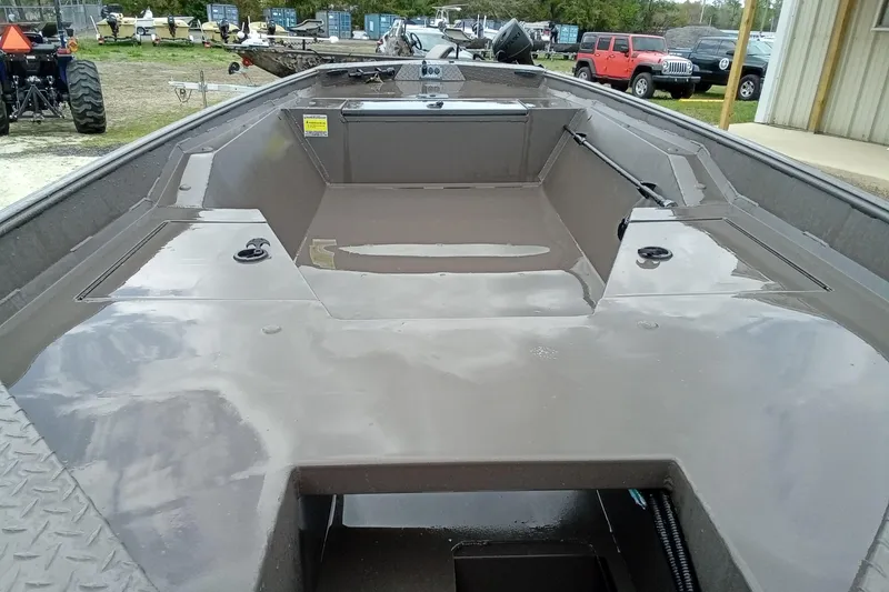 Slide: The Image of 2025 Alweld 1548 Invader boat with Tohatsu engine on trailer, outdoor setting. - 13