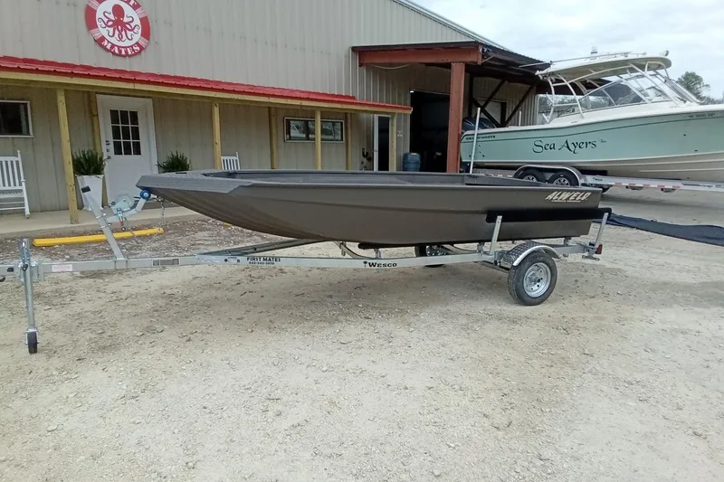 Slide: The Image of 2025 Alweld 1548 Invader boat on trailer outside a building. - 4