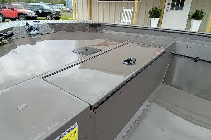 Slide: The Image of 2025 Alweld 1548 Invader boat with textured deck, parked outdoors. - 9