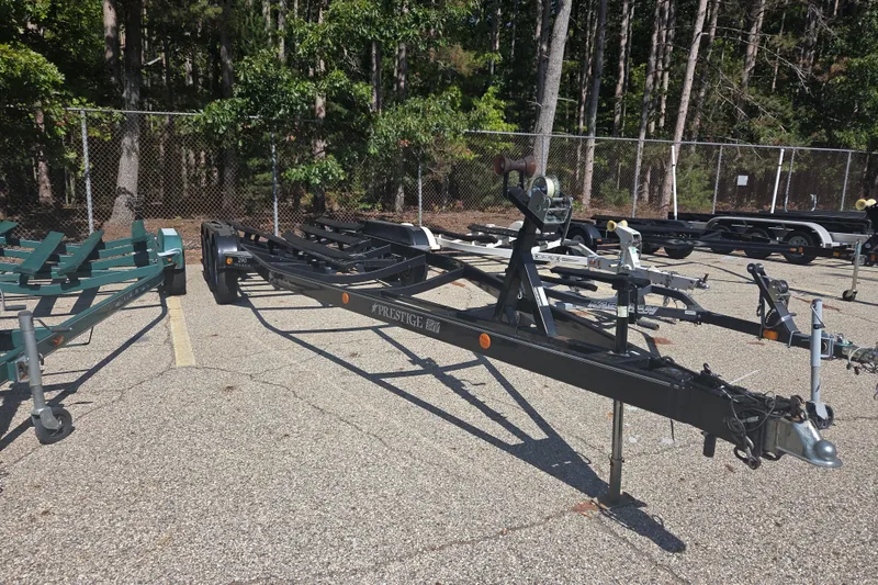 Slide: The Image of Boat trailers parked in a lot, surrounded by trees, for a 2006 Sea Ray 290 Select EX. - 10