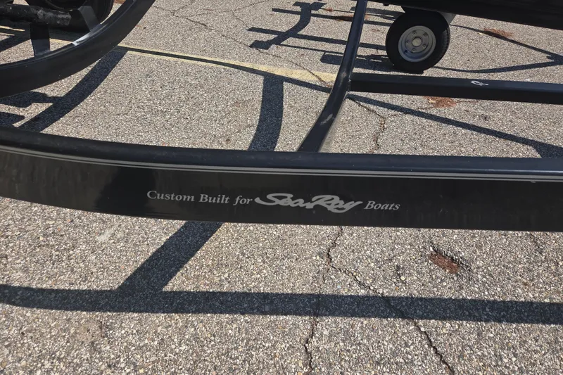 Slide: The Image of Trailer frame labeled "Custom Built for Sea Ray Boats" on pavement. - 11